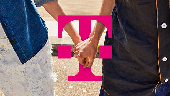 Two people holding hands over the Telekom logo